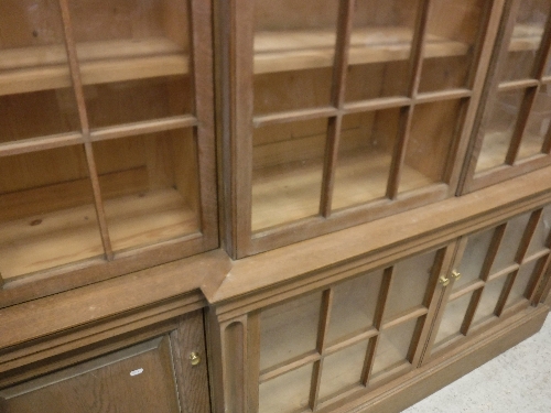 A large oak framed breakfront bookcase cabinet in the Arts and Crafts taste with six glazed and - Image 21 of 23