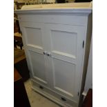 A childs white wood wardrobe with three quarter gallery top over two doors and one drawer size
