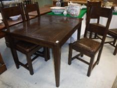 A modern oak rectangular extending dining table in the French taste raised on square tapered legs