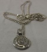 A 9 carat white gold and diamond set pendant of medallion form CONDITION REPORTS