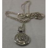 A 9 carat white gold and diamond set pendant of medallion form CONDITION REPORTS