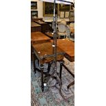 A wrought iron telescopic standard lamp in the Arts & Crafts style,