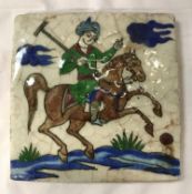 A circa 1860 Iranian / Persian Quajar tile depicting a polo player on horseback,