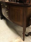 A Sheraton Revival mahogany and inlaid bow fronted sideboard with three drawers flanked by two