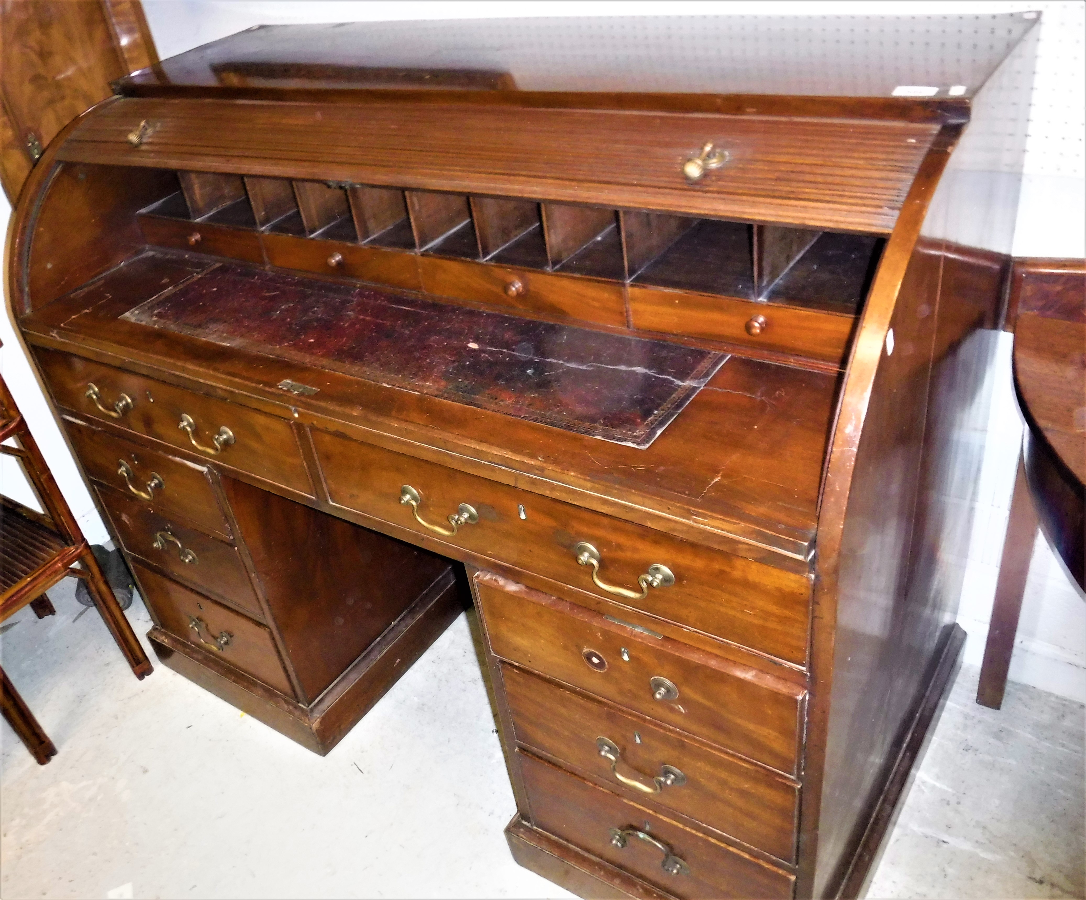 A mahogany tambour top desk in the George III taste,