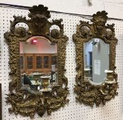 A pair of 19th Century Continental gilt brass girandole mirror with mask decorated surmounts and