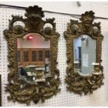 A pair of 19th Century Continental gilt brass girandole mirror with mask decorated surmounts and