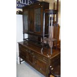 A leaded glazed two door cabinet, oak sideboard, oak plant stand,