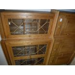 A modern pine breakfront bookcase cabinet with four astragal glazed cabinet doors over four drawers