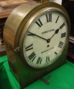 A brass cased dome top wall mounted clock, the movement by Thomas Armstrong & Bro.