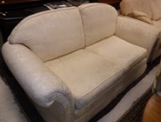 A cream floral upholstered two seat sofa and another similar two seat sofabed Size 192cm long x