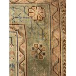 A large cream ground Indian wool rug,
