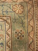 A large cream ground Indian wool rug,
