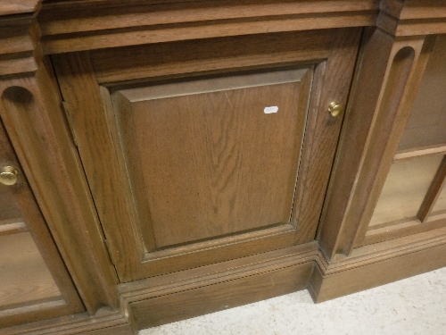 A large oak framed breakfront bookcase cabinet in the Arts and Crafts taste with six glazed and - Image 22 of 23
