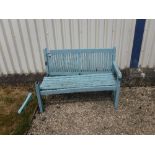 A green painted garden bench