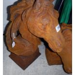A pair of cast irons horses heads on balls