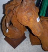 A pair of cast irons horses heads on balls