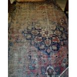 A Persian rug the central panel set with floral decorated medallion on a blue and red ground,