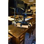 A modern mahogany sideboard, a modern oak desk and a modern office chair.