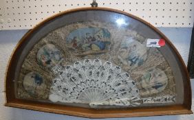 A 19th Century Continental bone fan decorated with hand-coloured engraved panels with figures in