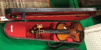 An early 20th Century child's violin in case, together with bow. Size approx.