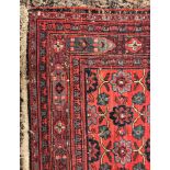 A large Persian rug with all over stylised medallion decoration on blue ground within a