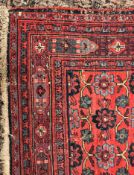A large Persian rug with all over stylised medallion decoration on blue ground within a