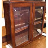 A Victorian mahogany glazed two door wall cabinet with adjustable shelving Size approx.