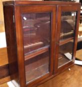 A Victorian mahogany glazed two door wall cabinet with adjustable shelving Size approx.
