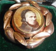 A Victorian yellow metal mounted mourning brooch set with hair to back and hand-painted