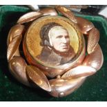 A Victorian yellow metal mounted mourning brooch set with hair to back and hand-painted