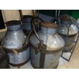 Three galvanised and iron bound milk churns and two metal framed dome top mirrors Size approx.