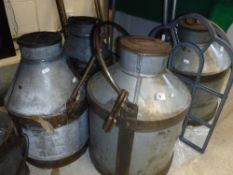 Three galvanised and iron bound milk churns and two metal framed dome top mirrors Size approx.