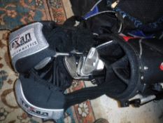 A golf bag and contents of Texan Titanium Matrix golf clubs including three drivers,