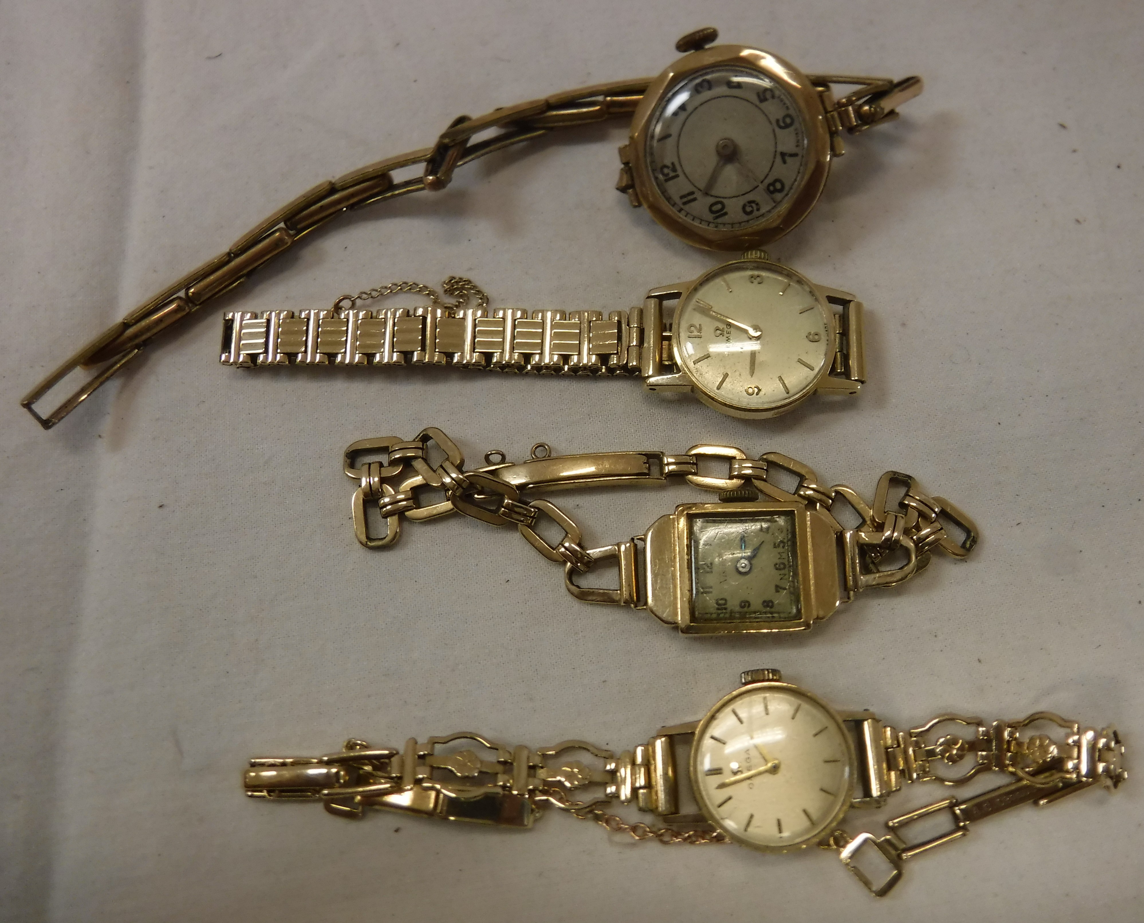 Two Omega 9 carat gold ladies wristwatches, together with two further 9