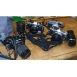 A collection of various cameras to include Canonet 28, Olympus OM-2, Olympus OM-10, Olympus OM-40,