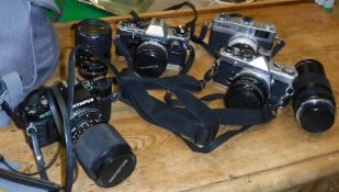 A collection of various cameras to include Canonet 28, Olympus OM-2, Olympus OM-10, Olympus OM-40,