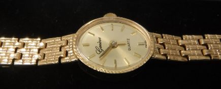 A 9 carat gold Geneve Quartz ladies wristwatch with 9 carat gold strap, approx 16.