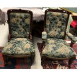 A late Victorian mahogany framed pair of ladies and gentleman's salon chairs with green foliate