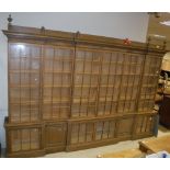 A large oak framed breakfront bookcase cabinet in the Arts and Crafts taste with six glazed and
