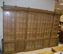 A large oak framed breakfront bookcase cabinet in the Arts and Crafts taste with six glazed and
