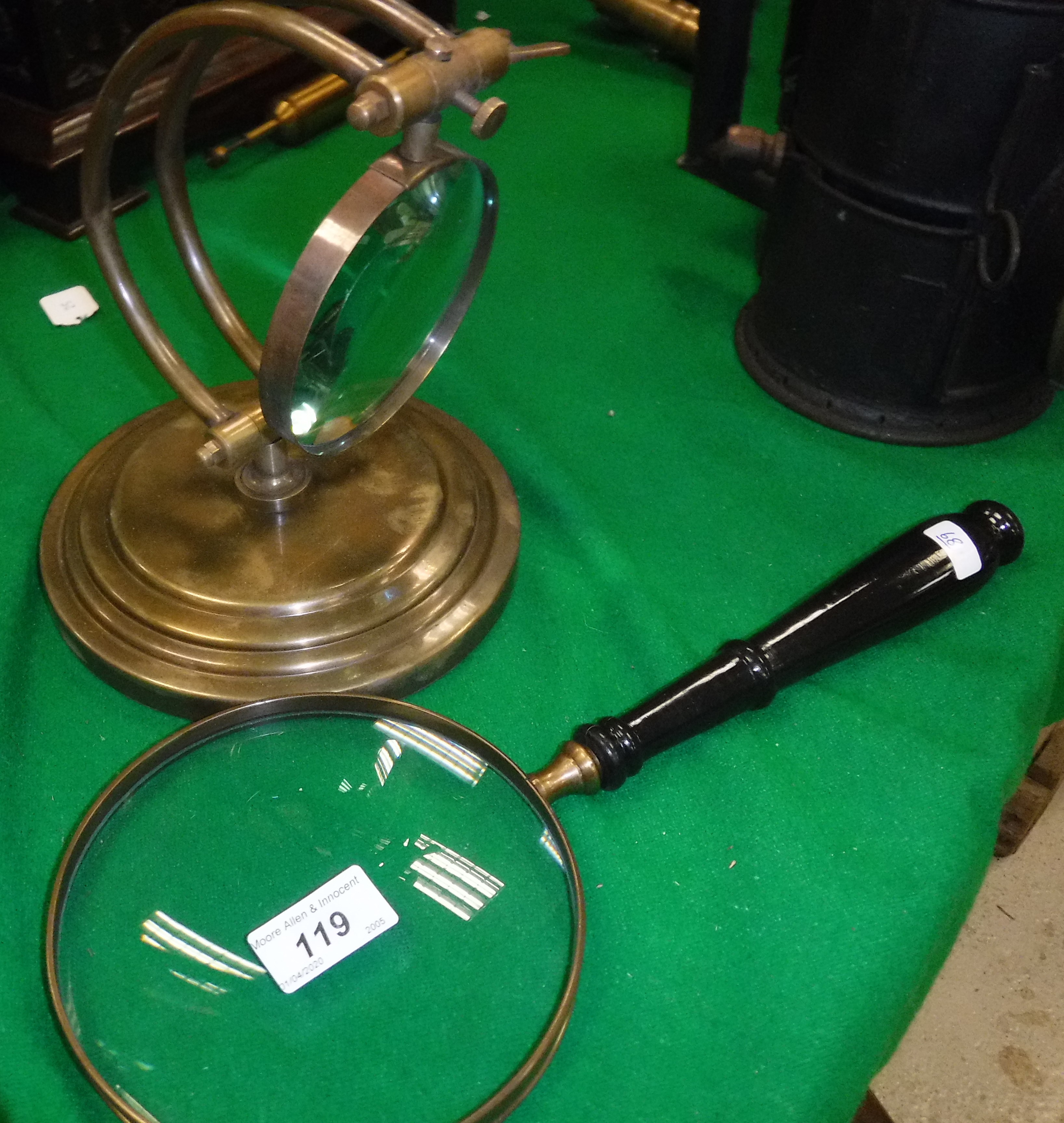 A 6" magnifying glass with ebonised handle and a brass table magnifying glass