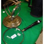 A 6" magnifying glass with ebonised handle and a brass table magnifying glass