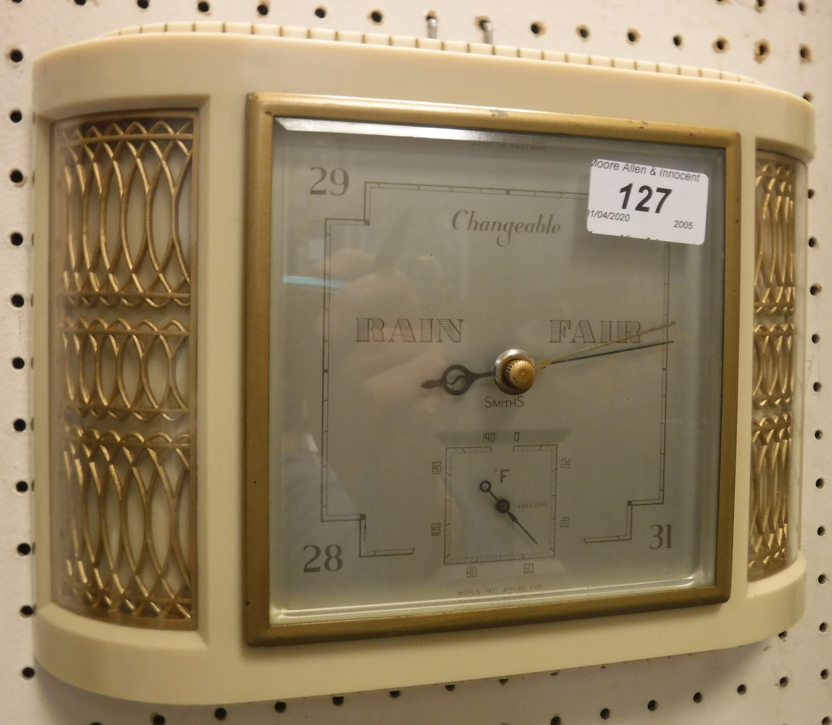 A Smith's wall barometer in white plastic and gilded bow fronted case in the Art Deco taste,