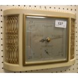 A Smith's wall barometer in white plastic and gilded bow fronted case in the Art Deco taste,