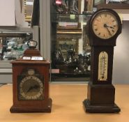 An oak mantel clock with English movement, the brass dial set with Roman numerals,