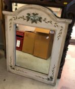 A white painted wooden framed wall mirror with applied painted white roses,