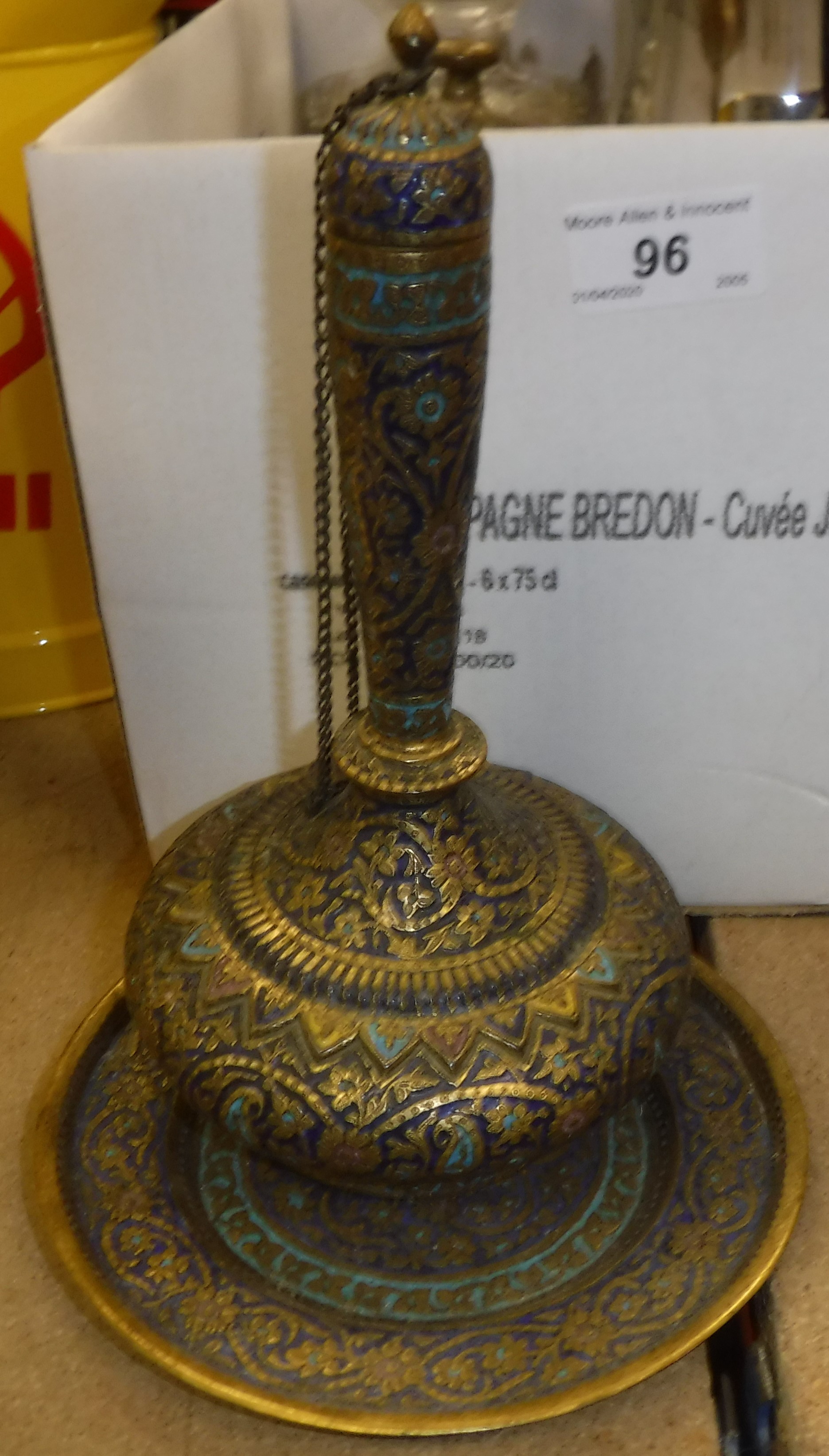 A box containing various decorative items including an Indian enamelled gilded bottle and matching