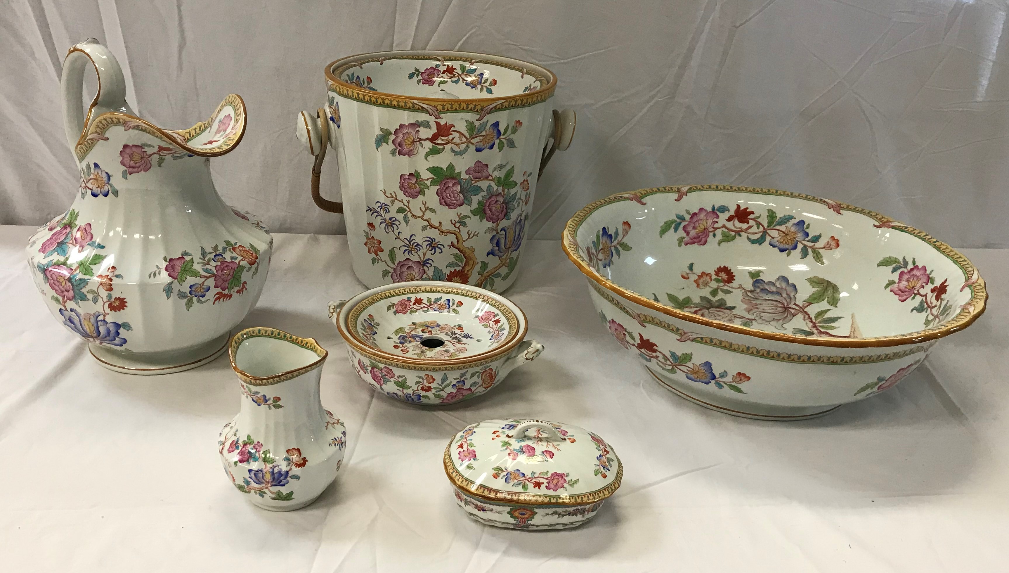 A late Victorian Cauldon china six piece floral transfer decorated toilet set,