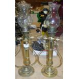 A pair of brass gimble candle lights with glass shades. Size approx.